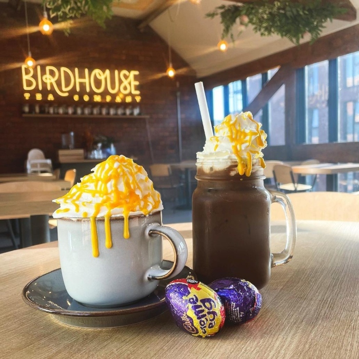 Warm white Custom Neon® logo sign on a brick wall @birdhouseteacompany