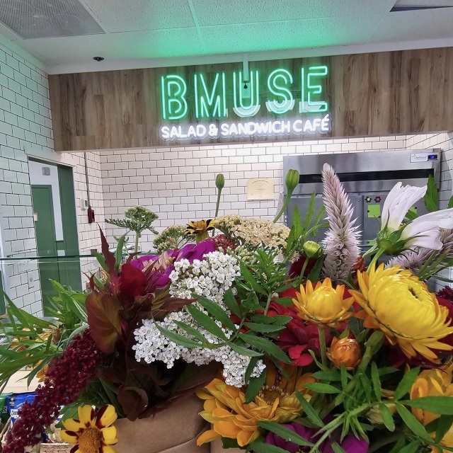 Green and white logo sign by Custom Neon® @bmusecafe.middlebury