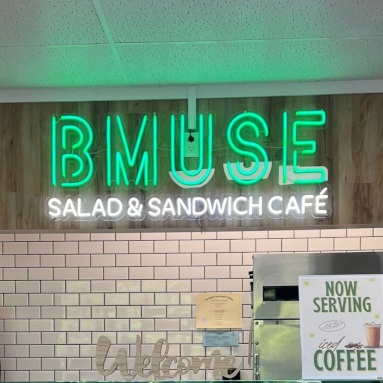 Green and white logo sign by Custom Neon® @bmusecafe.middlebury