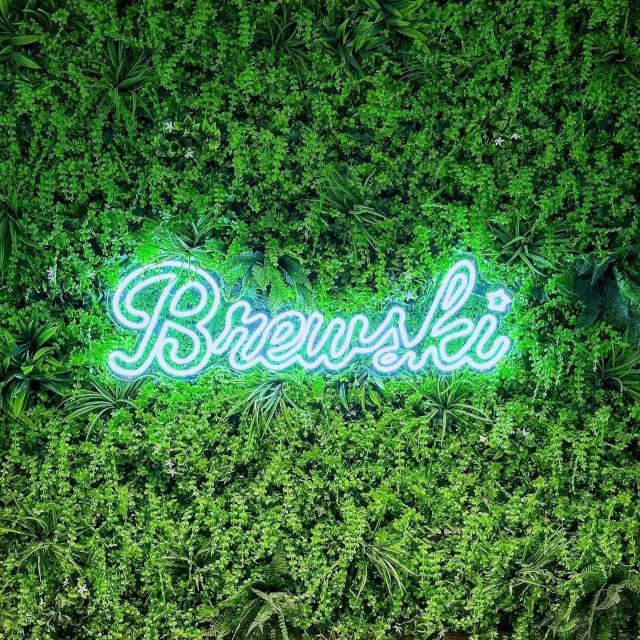 White restaurant name sign by Custom Neon® @brewskirestaurants