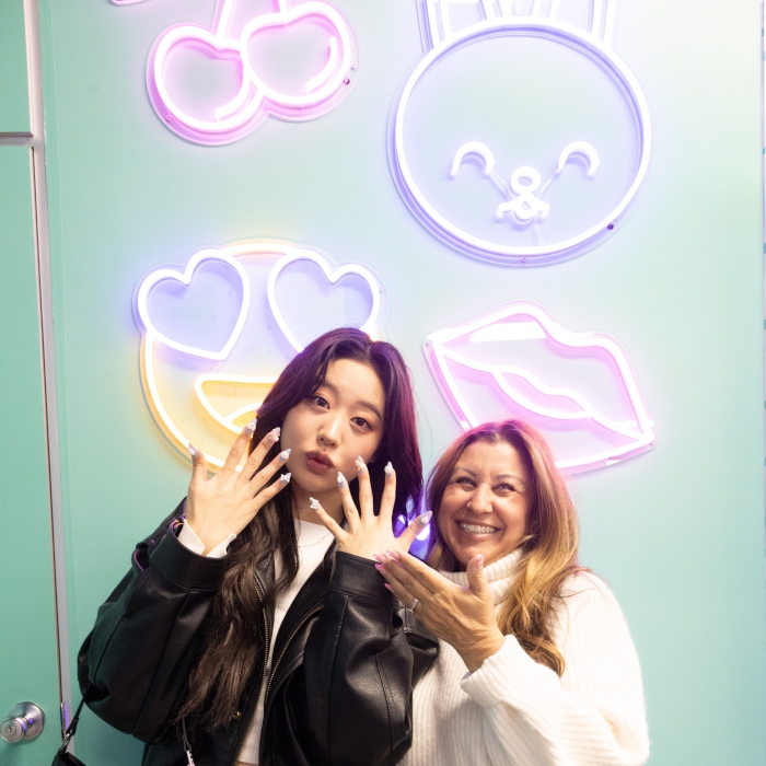 Custom Neon® LED neon emoji signs on a pale green wall in the Samsung Flip Side Pop-Ups