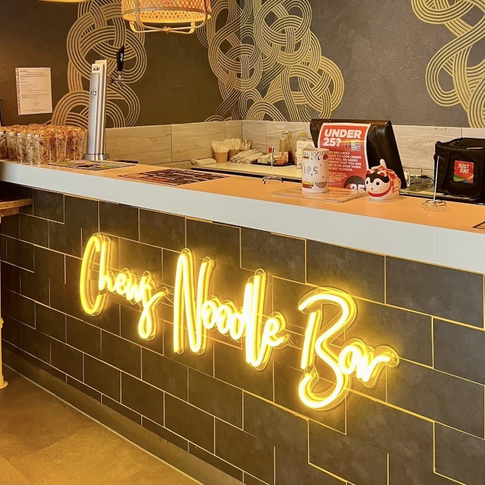 Yellow Custom Neon® restaurant name sign @chewsnoodlebar