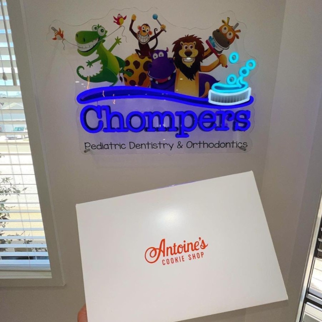 Chompers colourful logo sign on a white wall at the Chompers Dental clinic