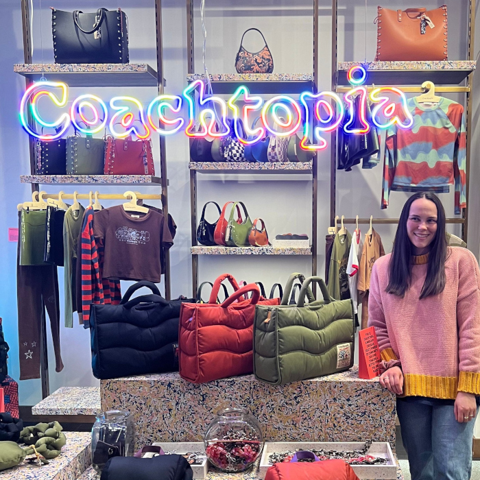 Coachtopia colourful LED neon logo sign made by Custom Neon&reg; using waste products hanging from the ceiling of the in The Grove, LA, Coach store