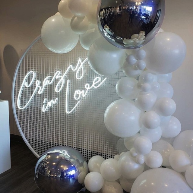Custom Neon® white Crazy in Love sign on circular wire mesh frame with white and silver balloons - event decor by @decorandfiesta