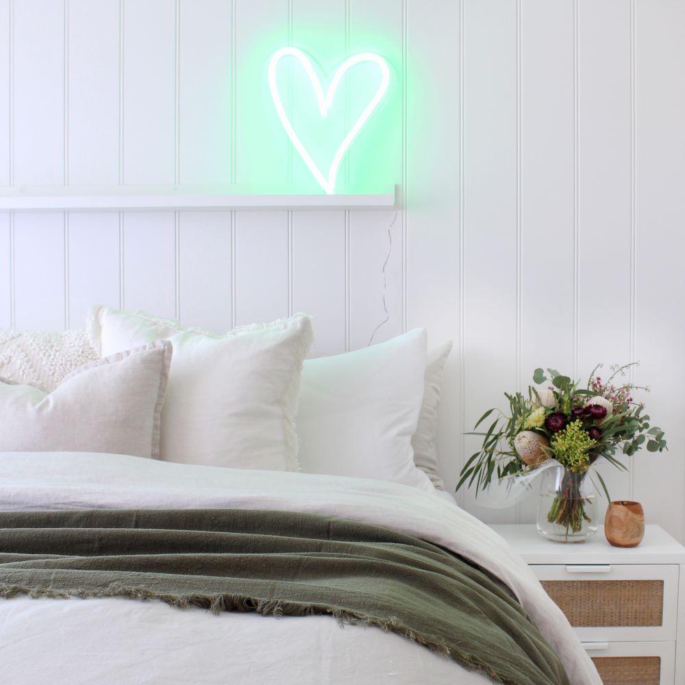 Custom Neon® mint green heart in a bedroom