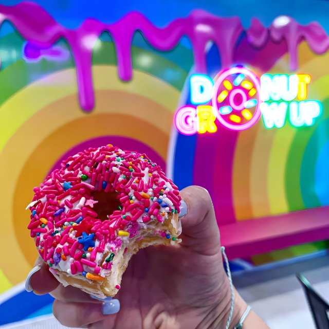 Colorful Custom Neon® sign on a rainbow wall @sundaedonuts