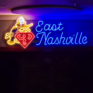 Dark blue, red and yellow Custom Neon® logo sign at the East Nashville Fire Department @eatatbento