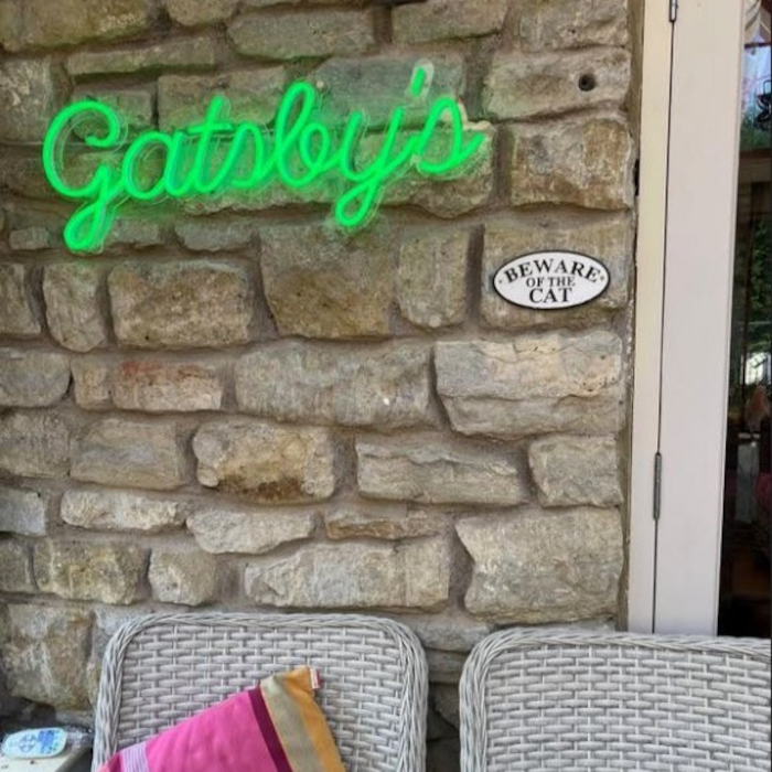 Custom Neon® family name house sign on patio wall