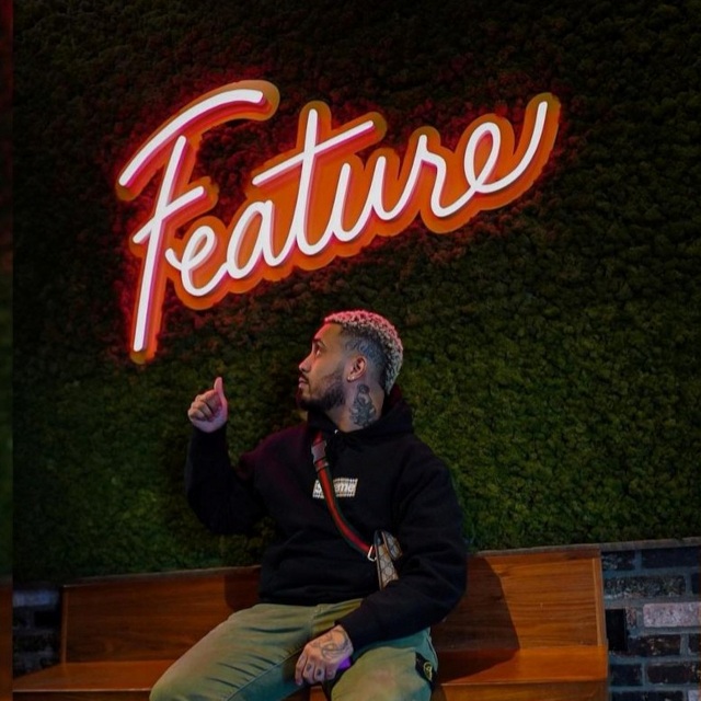 Custom Neon® retail store logo sign on a grass wall made for @feature