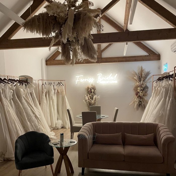 Ferris Bridal Home of Curves warm white Custom Neon® sign on a white wall in a bridal store