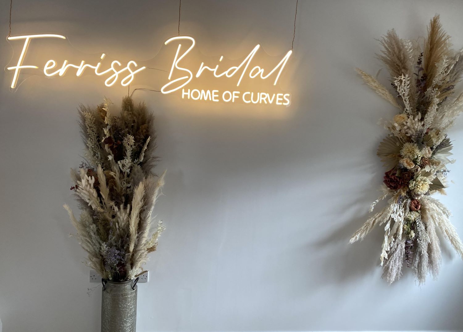Custom Neon® warm white bridal store sign on brick wall @ferrissbridal