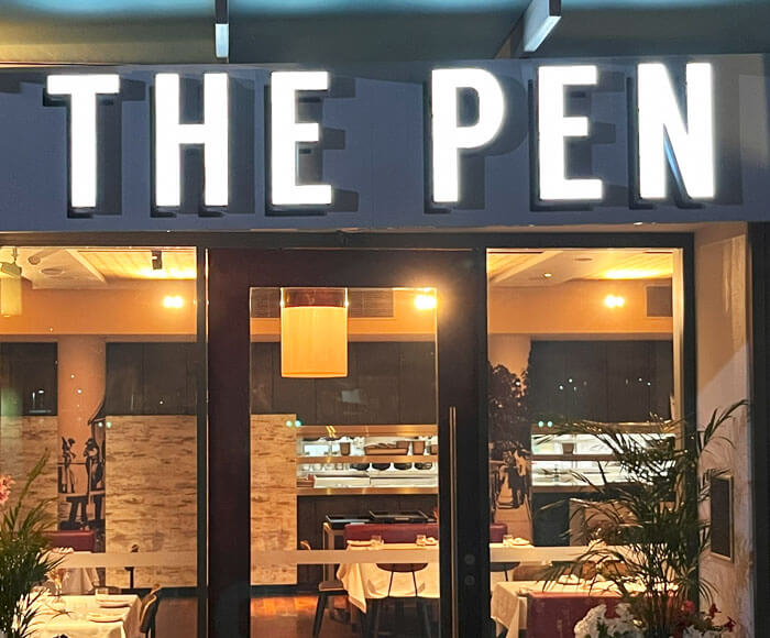 The Pen front lit restaurant sign at night