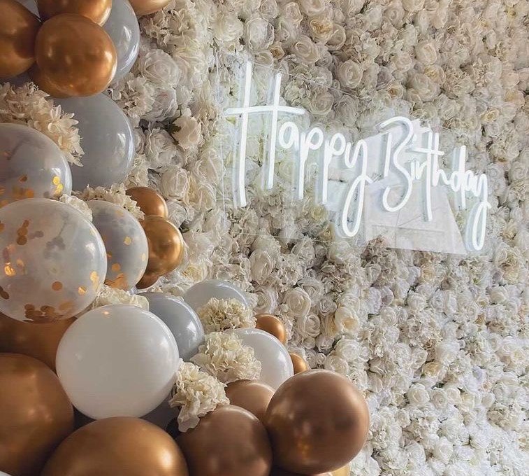 Custom Neon® Happy Birthday sign on white flower wall @effortless_elegance_uk