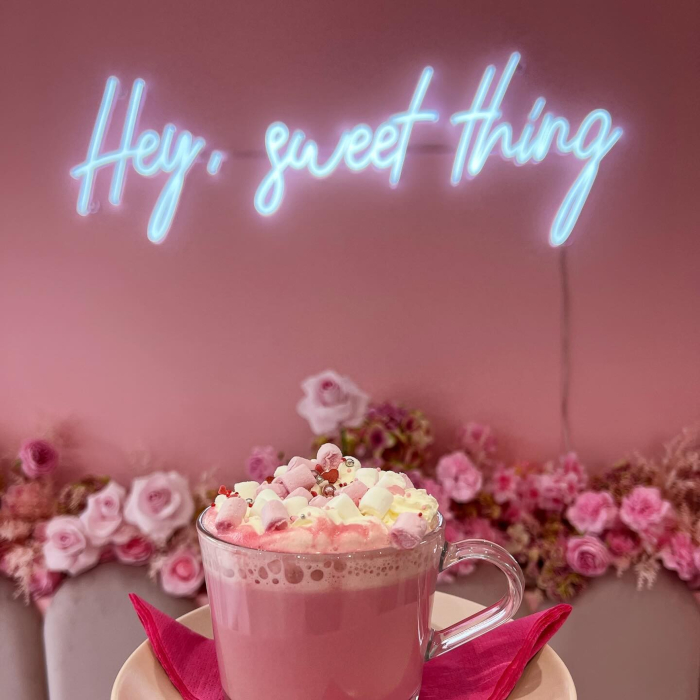 White Custom Neon® selfie wall bakery sign @cheshirecupcakes