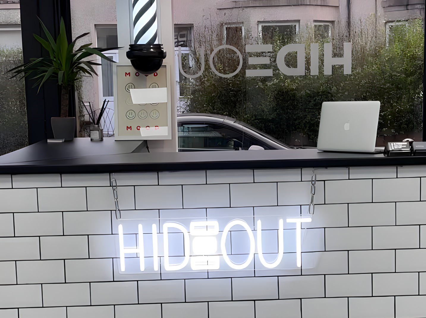 White Custom Neon® logo sign made for @hideout.barbers