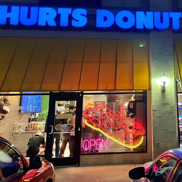 Custom Neon® pink Open sign in the window @hurtsdonutco