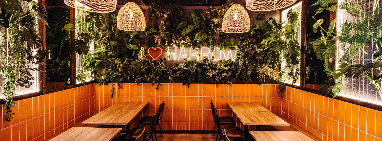 I Love Harrow Custom Neon® sign on lush plant wall @mktplce.uk