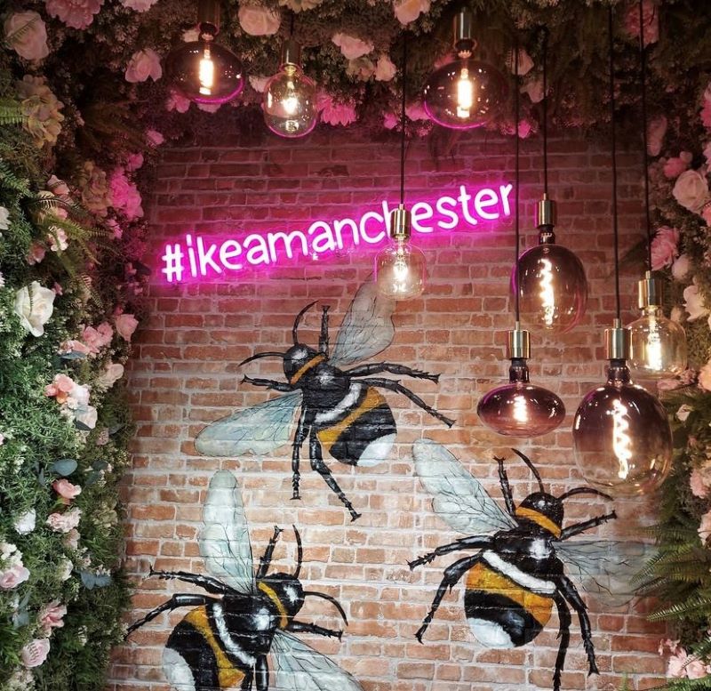 #ikeamanchester pink Custom Neon® hashtag sign on brick wall surrounded by florals @ikeauk