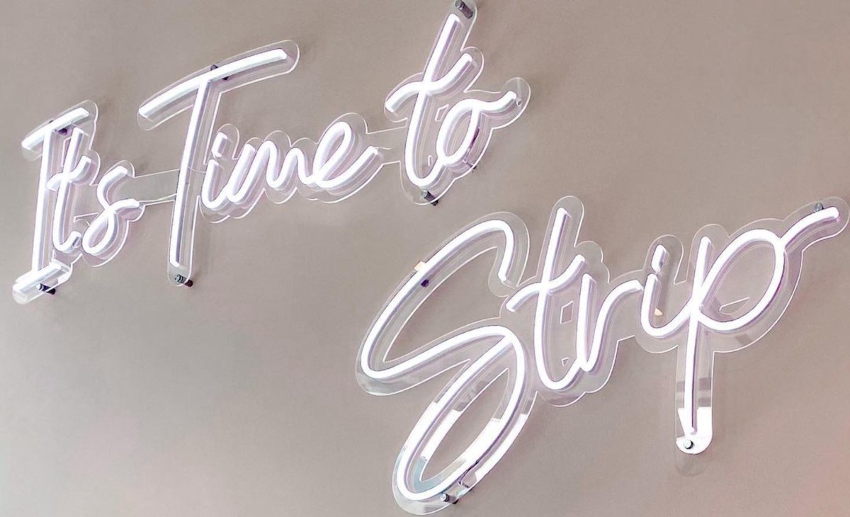 It's Time to Strip white Custom Neon® sign on white wall @striphairremovalexperts