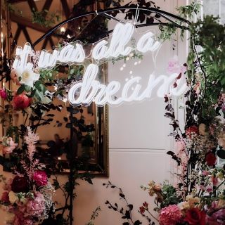 Custom Neon® white It Was All a Dream wedding quote sign on floral arch