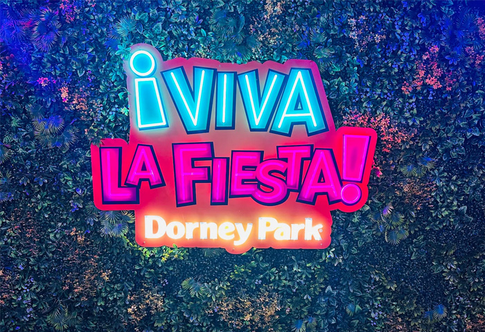 Colourful LED neon ice cream store sign with UV printing infills on a blue wall