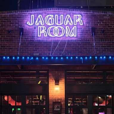 Purple Custom Neon® exterior building sign @jaguarroomdenver