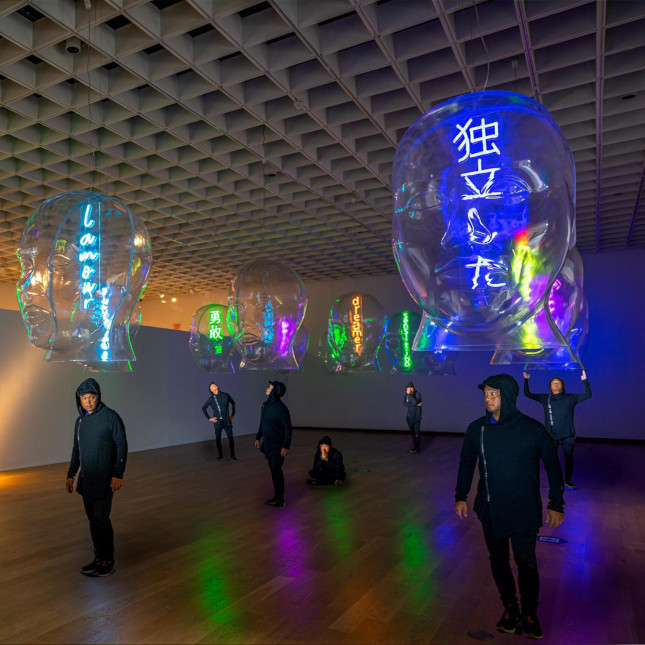 Custom Neon® signs hung from the ceiling inside Jefre's Taking Heads art exhibit at the Orlando Museum of Art