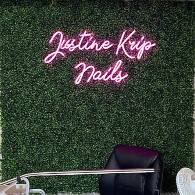 Custom Neon® nail salon name sign on grass wall @justinekripnails