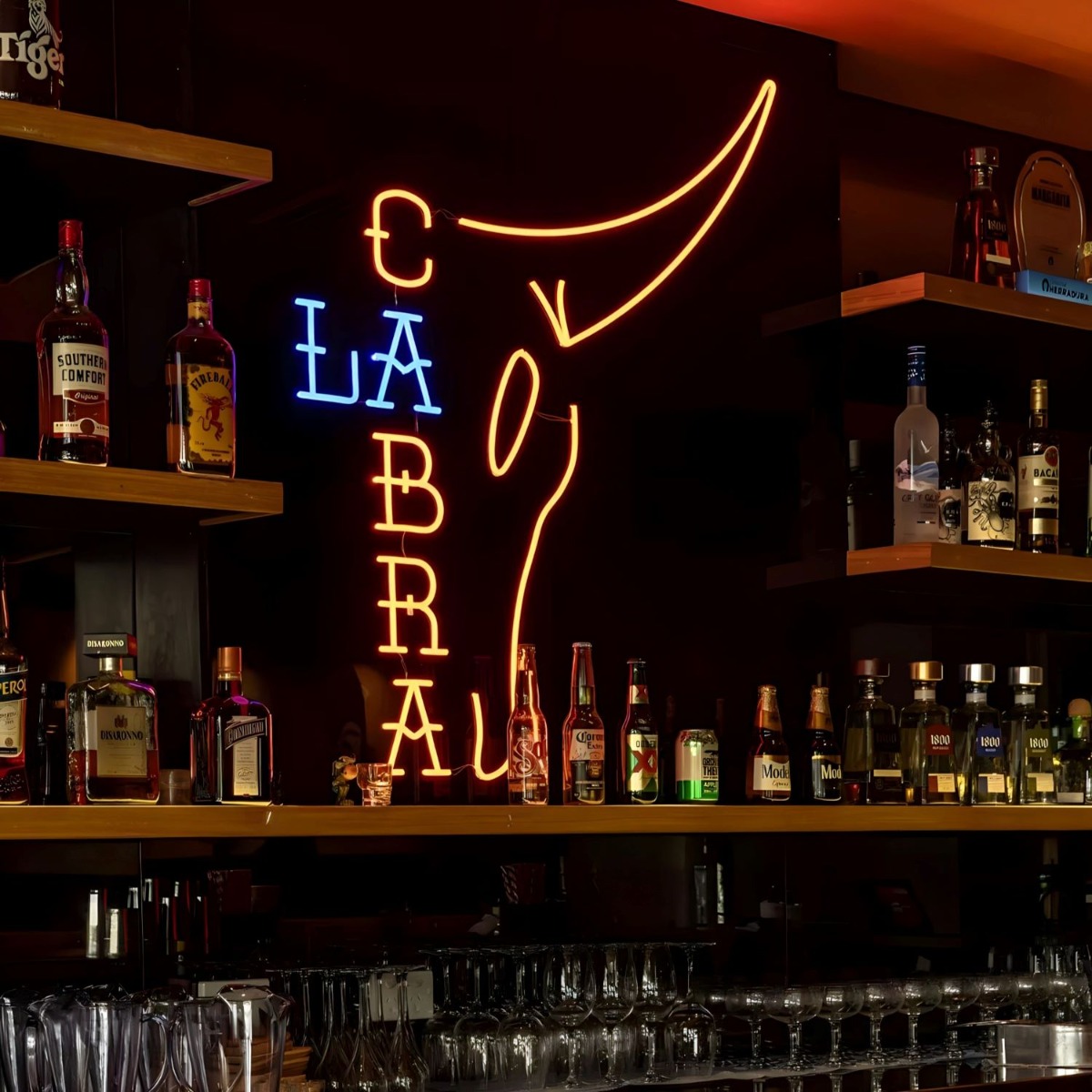 Custom Neon® made Mexican restaurant logo behind the bar @lacabramexican