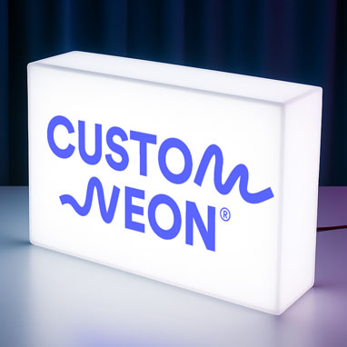 A fully illuminated light box with the Custom Neon® logo
