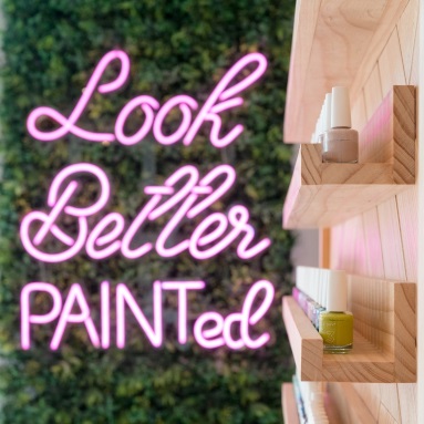 Look Better Painted baby pink Custom Neon® tagline sign on greenwall @paintgardenoaks