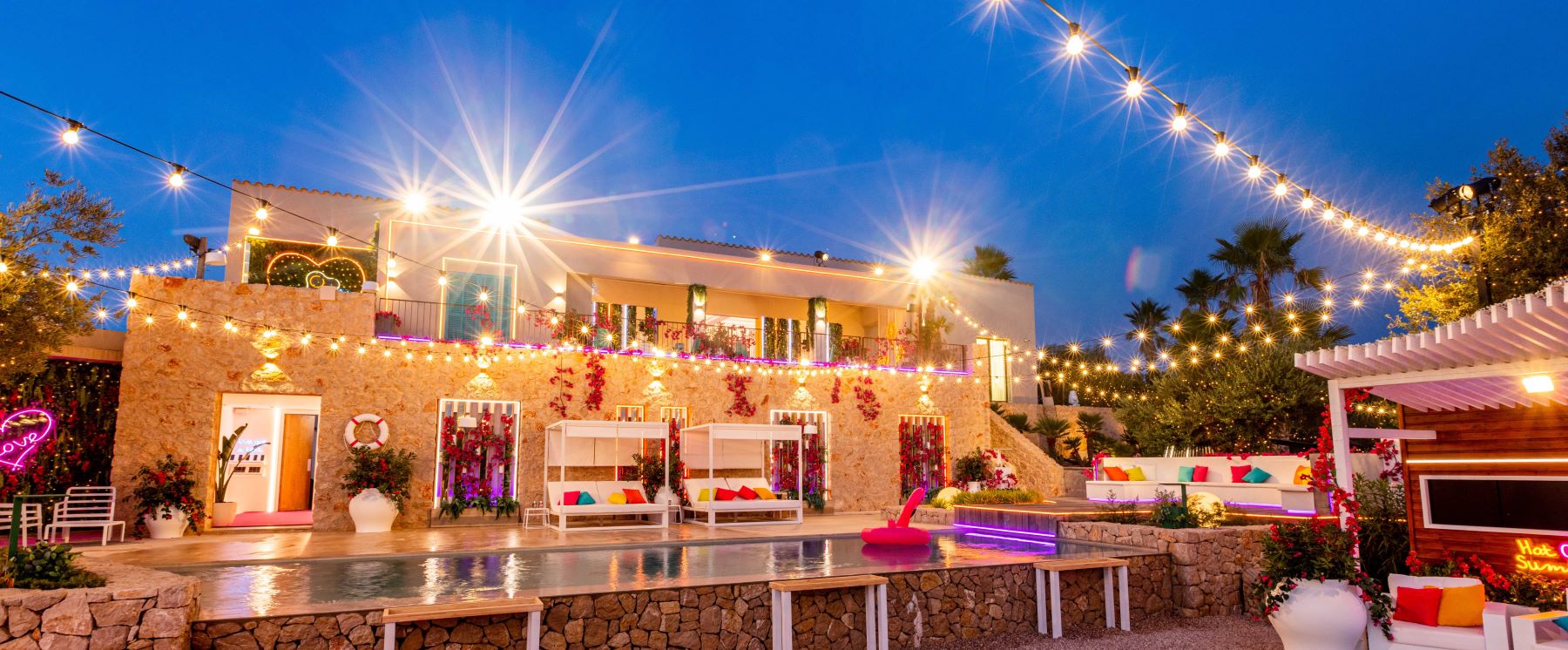 Custom Neon® signs light up the Love Island Australia Villa at night