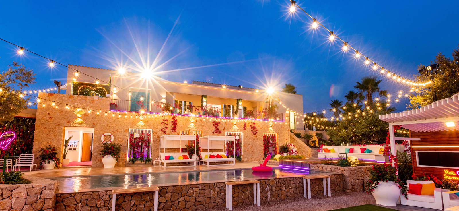 Custom Neon® signs light up the Love Island Australia Villa at night