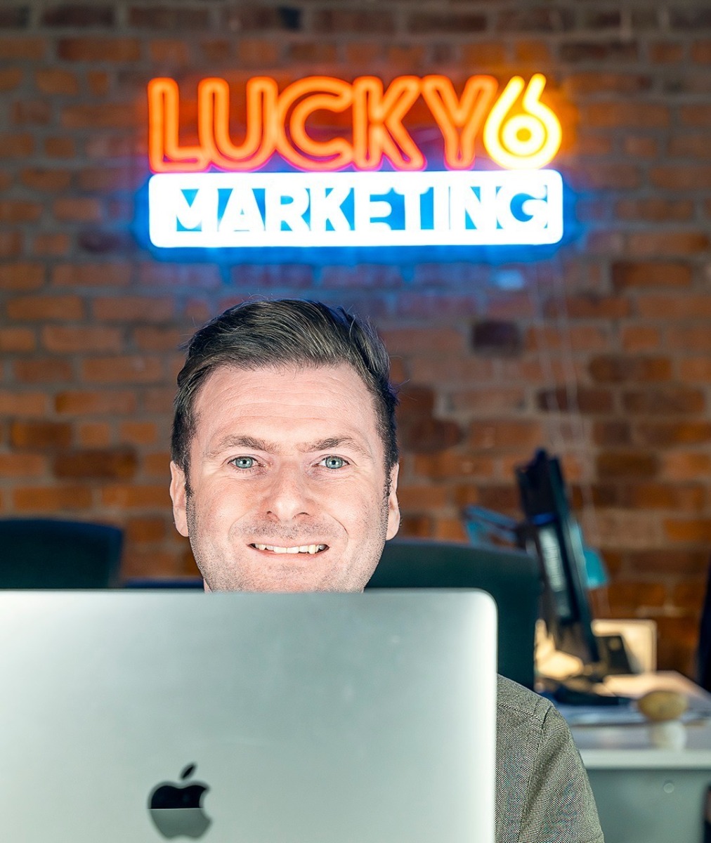 Custom Neon® colourful office logo sign on brick wall @lucky6marketing