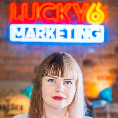 Colorful Custom Neon® office logo sign on a brick wall @lucky6marketing
