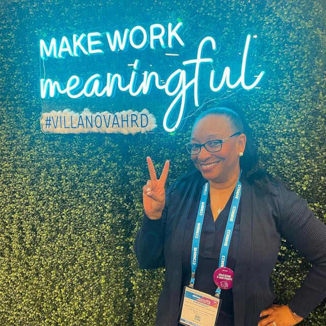 Custom Neon® LED neon UV print conference sign on grass wall @villanovahrd @shrmofficial