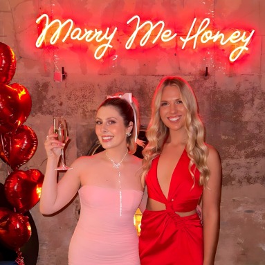 Marry Me Honey red Custom Neon® selfie backdrop sign on a distressed concrete wall