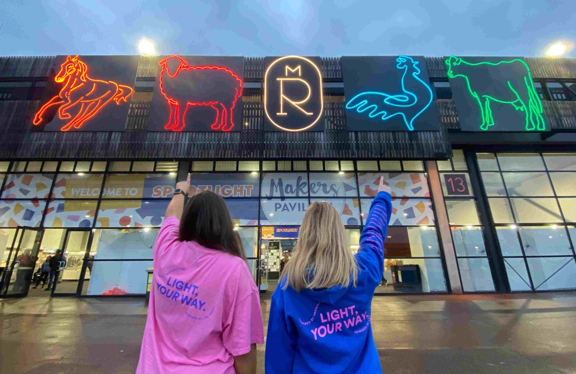 Huge Custom Neon® art depicting farm animals and the Royal show logo installed on the top of the pavilion at the Royal Show @melbourneroyalshow