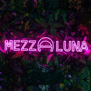 Pink Custom Neon® grass wall logo sign @mezzalunabristol