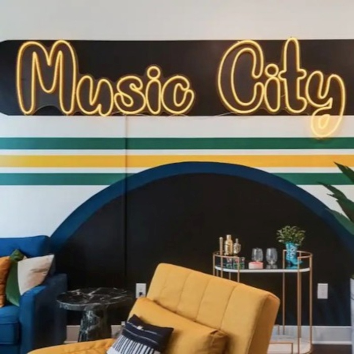 Music City retro font orange LED Custom Neon® sign in a living room designed by Somerled