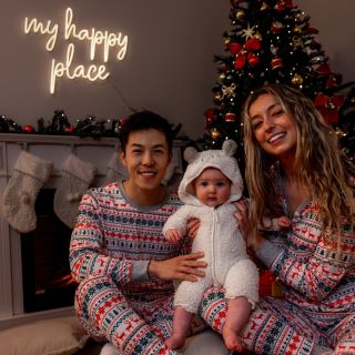 Custom Neon&reg; white My Happy Place sign above the mantlepiece next to a Christmas tree and decorations