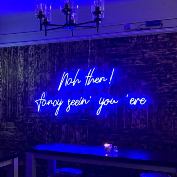 Large blue Custom Neon® quote sign reading Nah Then Fancy Seeing You 'ere @emzrestaurant_lounge