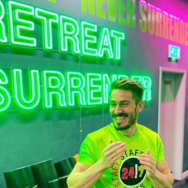 Never Retreat large green Custom Neon® sign on the wall @247fitnesssgym
