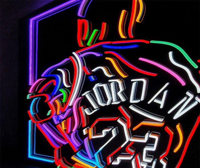 Custom Neon® multi-coloured LED neon sports star artwork on glossy black acrylic