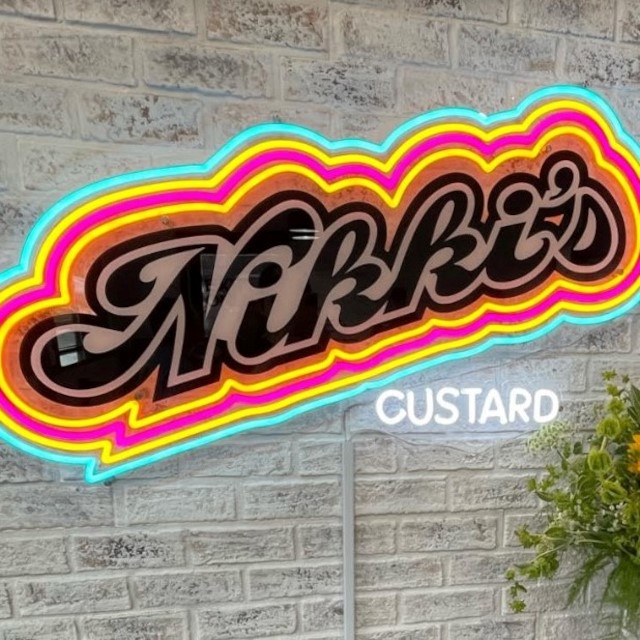 Custom Neon® colourful UV printed logo on brick wall @nikkiscustard