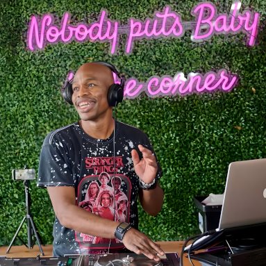 Nobody puts baby in the corner dark pink Custom Neon® sign on a green wall