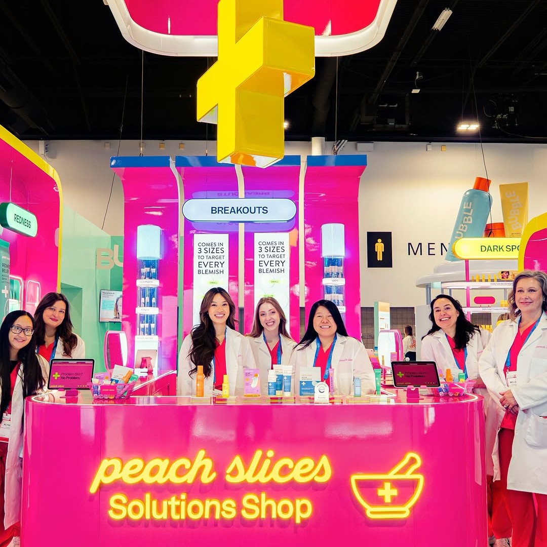 Custom Neon® lightbox signs hanging from the Peach Slices tradeshow booth