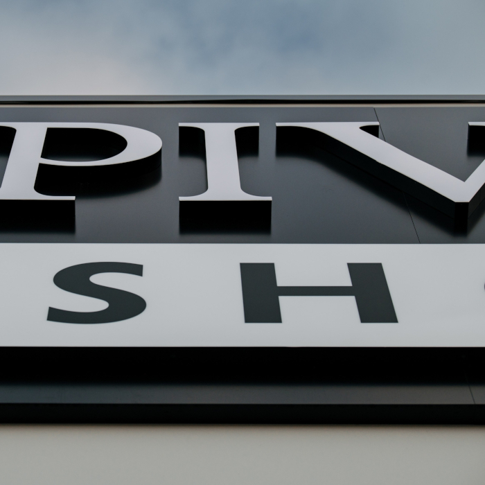 Close up of the Pivot Stove & Heating channel letters in daylight