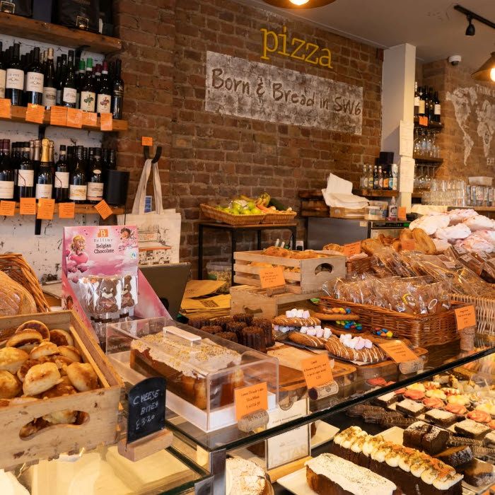 Pizza orange Custom Neon sign on a brick wall above the baked goods on display @bridge_baker